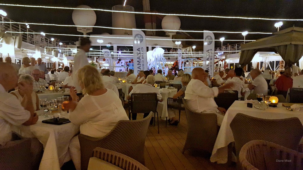 People eating dinner on cruise deck under the stars