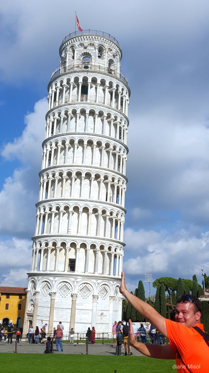 Man mock holds the Leaning Tower of Pisa