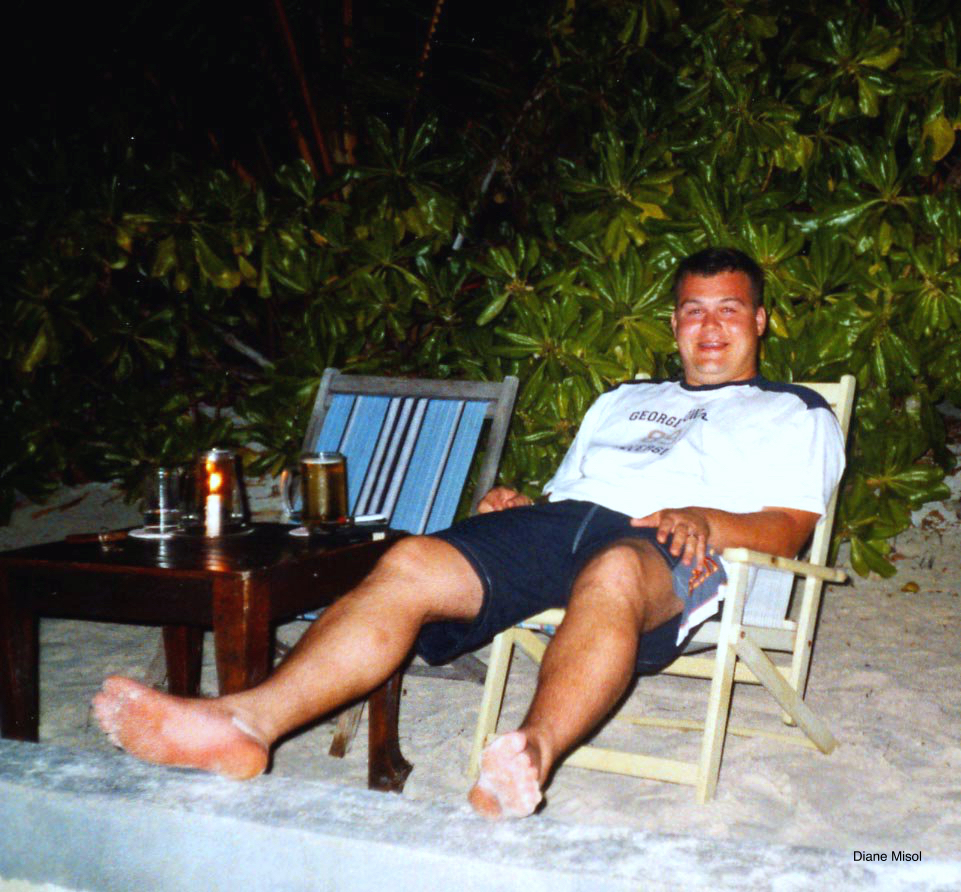 Man relaxes at night on beach