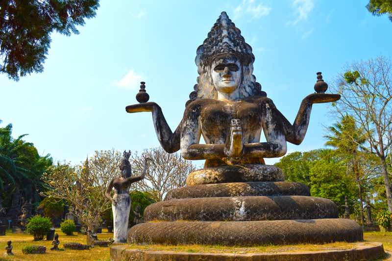 Four Armed Lady, Prayer and Offerings - Buddha Park, Vientiane, Laos