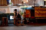 Street Vendor Watches a Soap Opera - Chiang Mai, Thailand